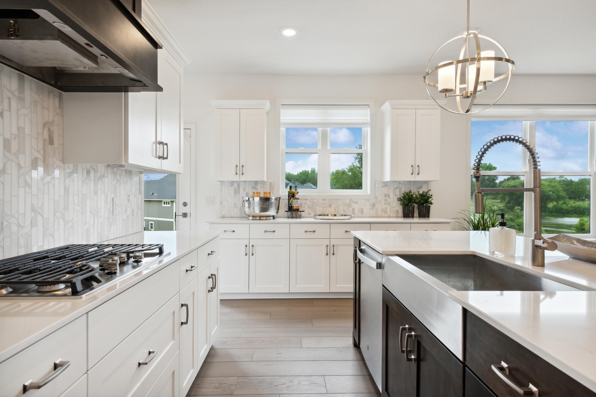 (Photo of model home, finishes will vary) For home chefs of all skills levels, this gourmet kitchen showcases an inviting center island, extensive cabinetry for abundant storage space and high-end double wall ovens to craft feasts of all sizes.