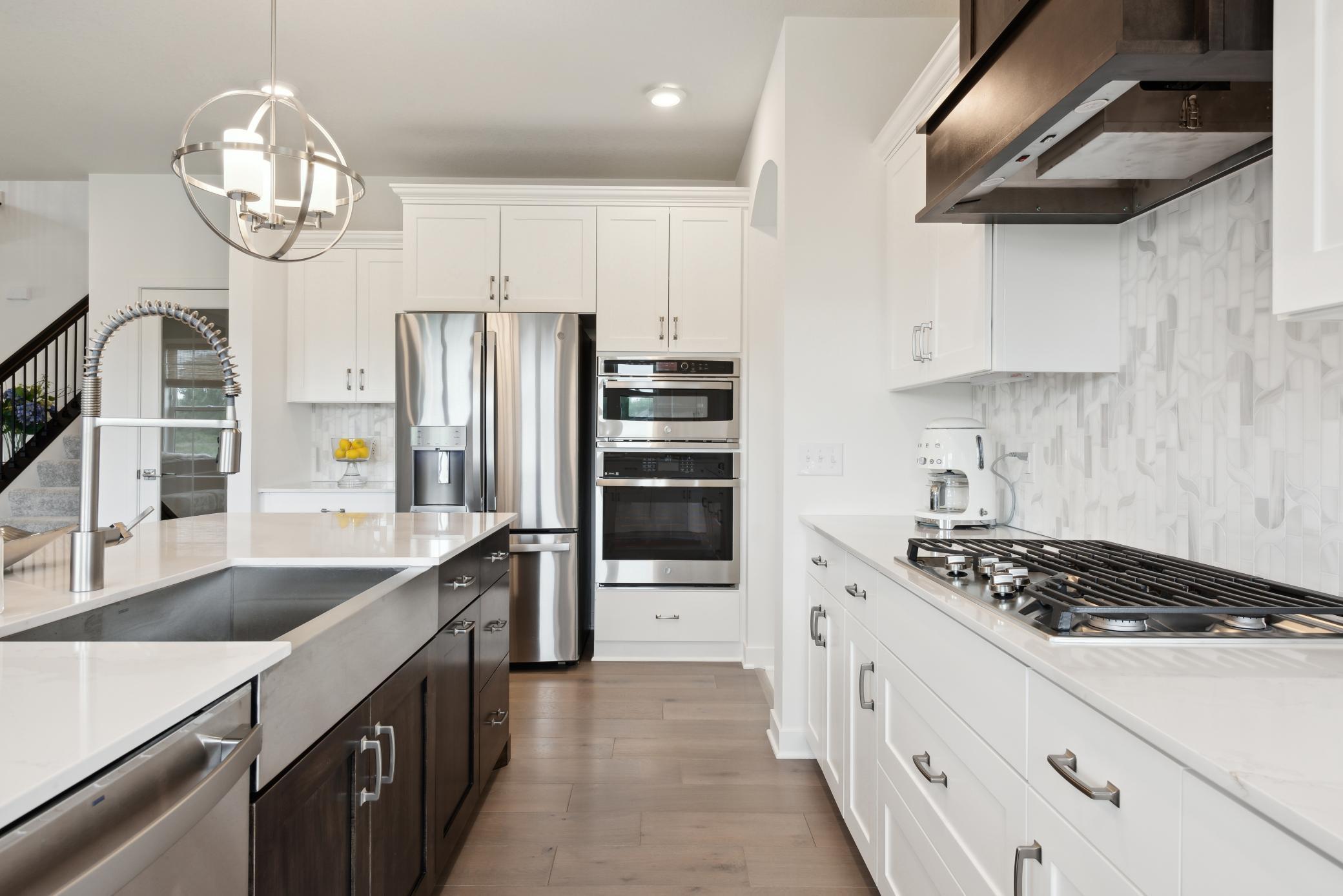 (Photo of model home, finishes will vary) Thanks to the home’s spacious, free-flowing layout, residents and guests can migrate from drinks at the center island to dinner and entertainment