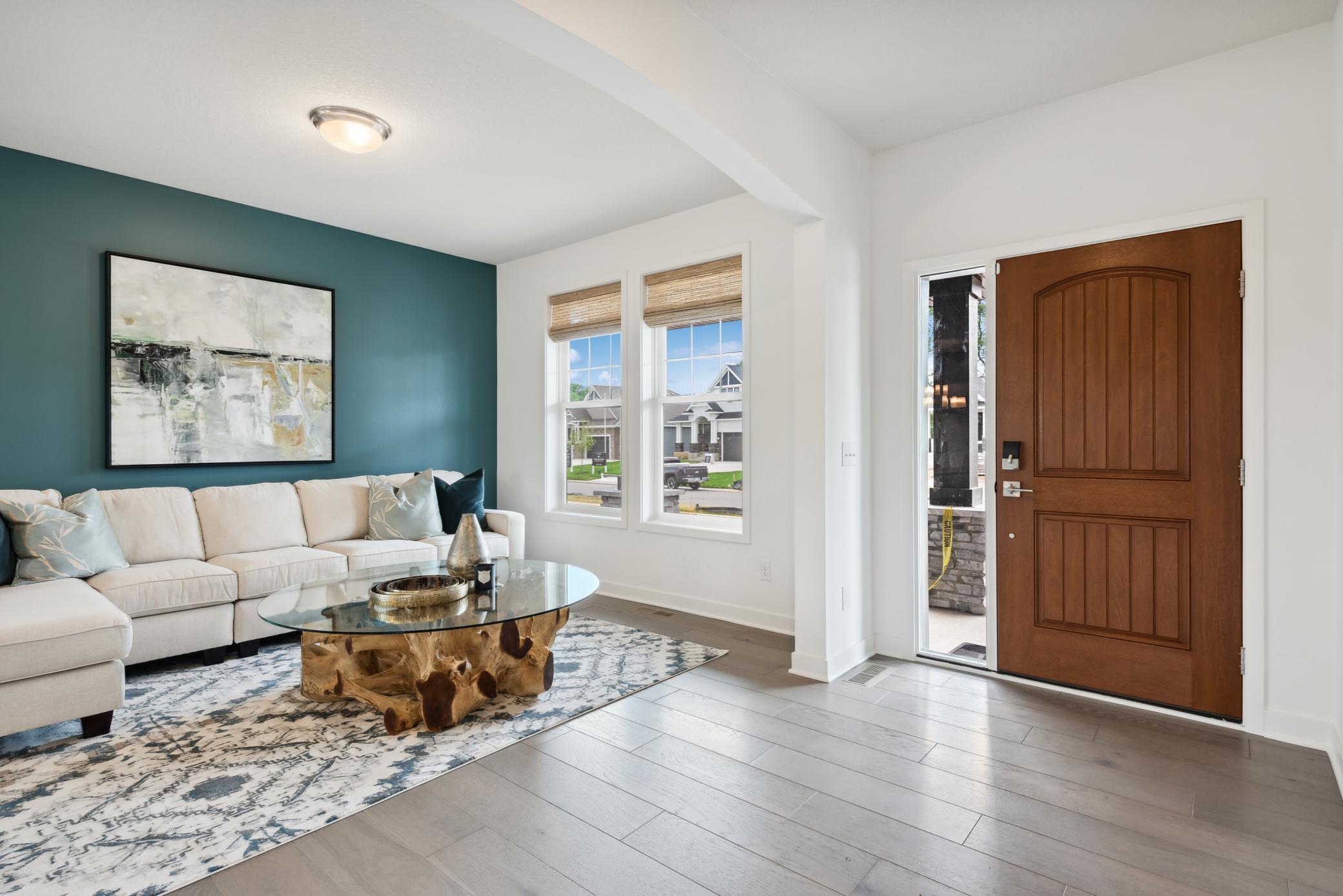 (Photo of model home, finishes will vary) Situated directly off the foyer, this living room can act as a quiet reading area or an elegant sitting room to host newly arrived guests.