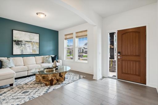 (Photo of model home, finishes will vary) Situated directly off the foyer, this living room can act as a quiet reading area or an elegant sitting room to host newly arrived guests.