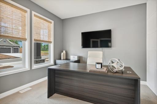 (Photo of model home, finishes will vary) French doors sequester this office from the rest of the open main living areas, ensuring additional privacy and quiet to concentrate on work.