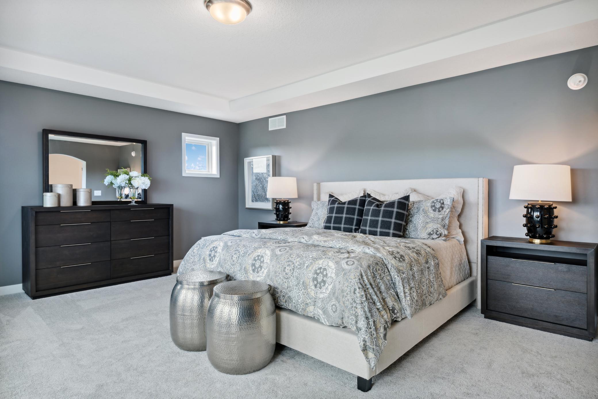 (Photo of model home, finishes will vary)The Owner's suite boasts a sprawling bedroom accented by a grand tray ceiling, a luxurious en-suite bathroom and an oversized walk-in closet.