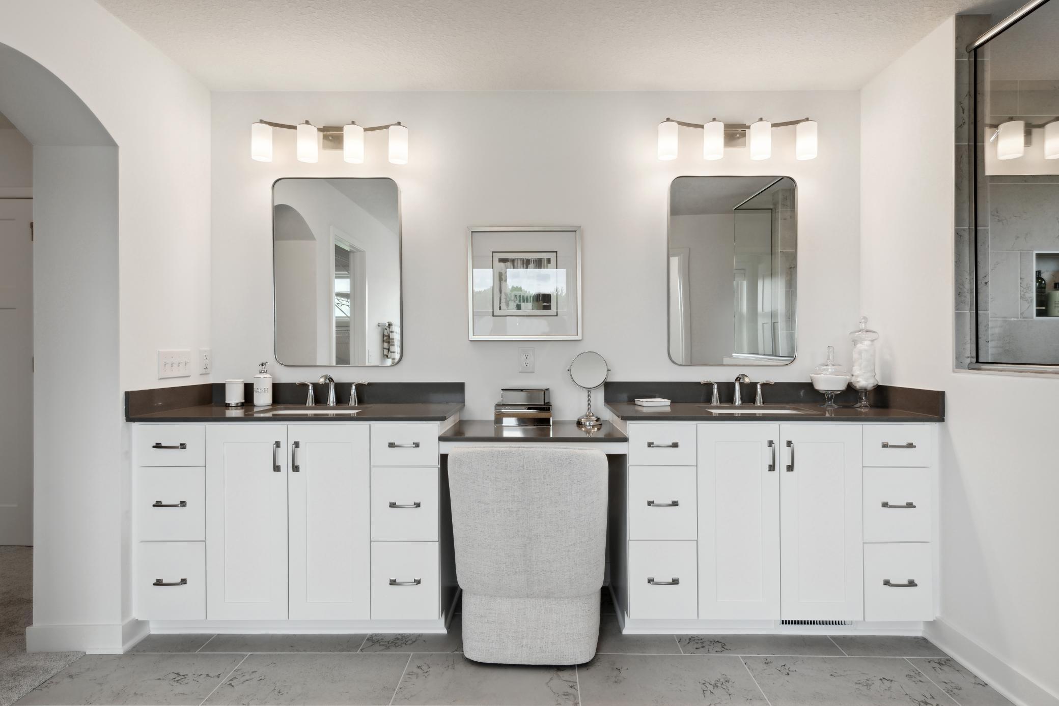 (Photo of model home, finishes will vary). Split vanities and individual mirrors allow homeowners ample personal space to greet the day