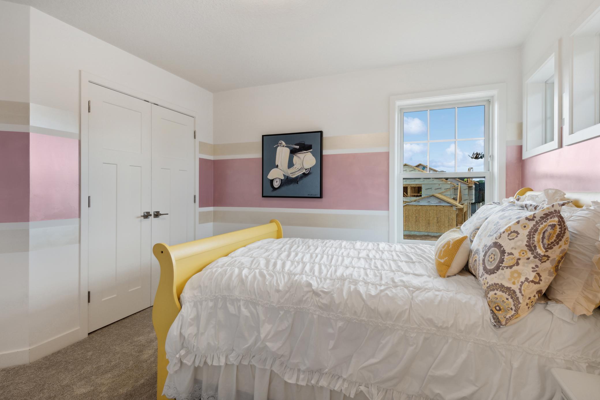 (Photo of model home, finishes will vary). Ideal for residents that require more personal space and privacy, this bedroom includes an attached full-sized along with a cozy nook by the window.