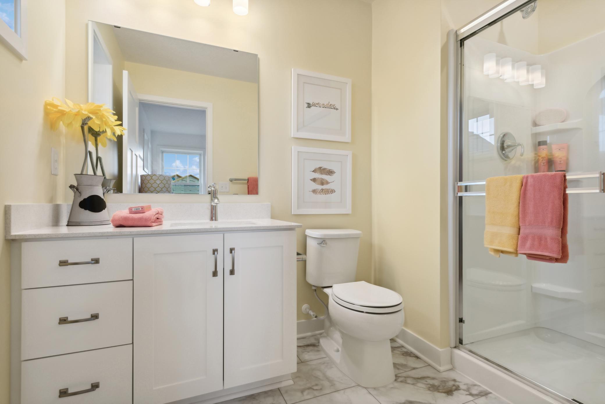 (Photo of model home, finishes will vary) Accessible from the adjoining bedroom, this en-suite bathroom offers a stylish vanity and a glass-enclosed shower.