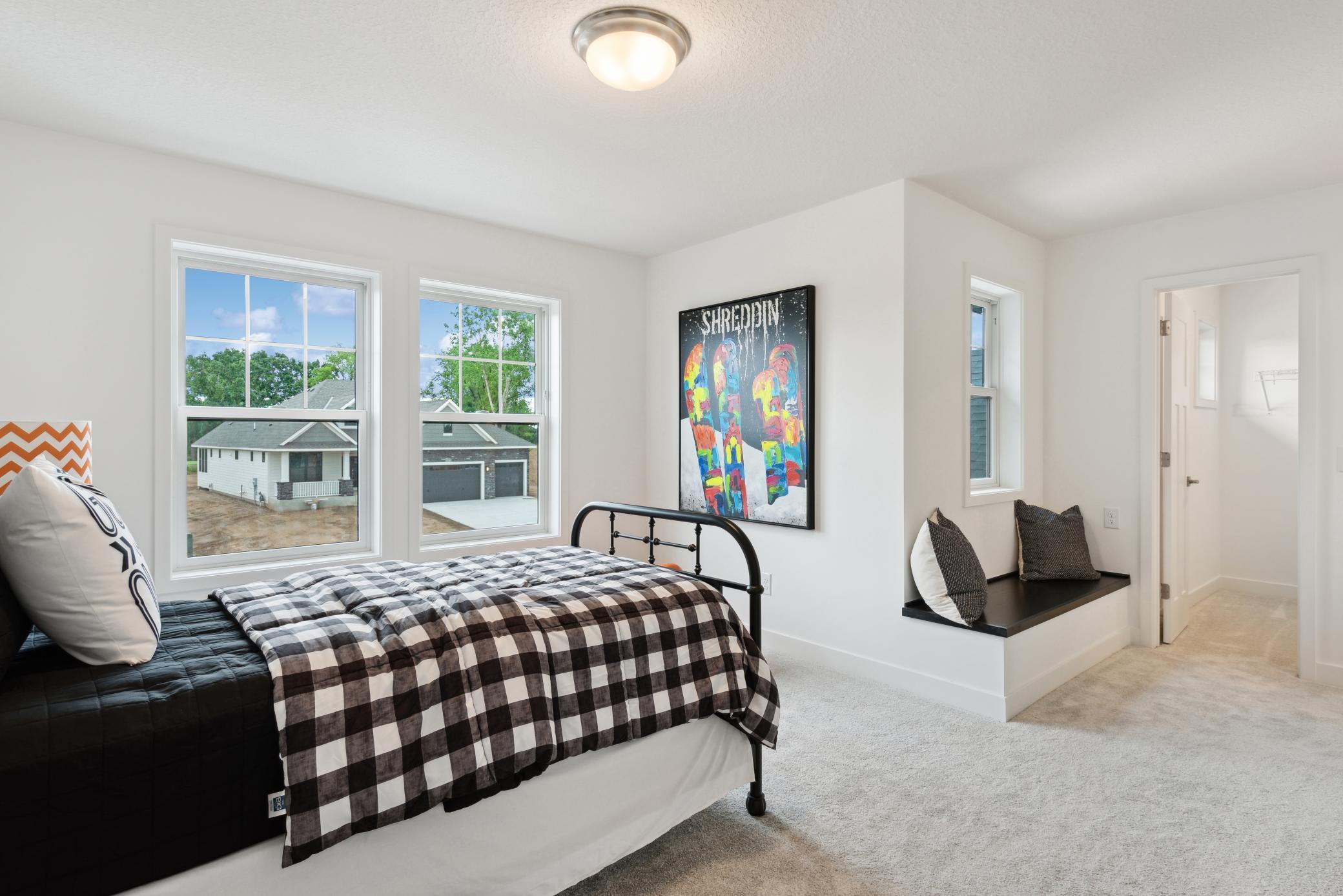 (Photo of model home, finishes will vary) Versatile in nature, this large upper-level bedroom can host twin bunk beds for younger residents that want to double up.