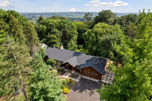 This exceptional home is brimming with sophisticated amenities, and is serenely set on a wooded paradise in a choice Highland Park neighborhood!