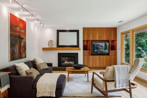 The sophisticated living room is accented with maple hardwood flooring and wonderful built-ins for your TV and AV equipment.