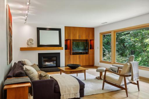 A wall of windows overlooks the backyard. The mood-setting gas fireplace is the focal point of the room.