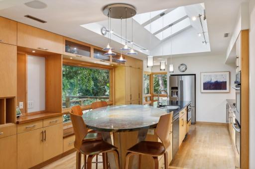 Brazilian marble countertops add character and style. The circular breakfast bar is accented with overhead lighting.