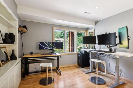 A flexible home office/study is adjacent to the foyer, and is enhanced with built-ins, recessed lighting, and corner windows. This space could be used as a bedroom to suit the changing needs of your household.