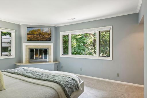 Escape to the spacious ownerâs suite to find a bedroom with soft neutral carpet, two generous closets, and a cozy fireplace.