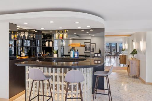 The circular bar is constructed of eye-catching glass block, and boasts counter seating with overhead recessed lighting.