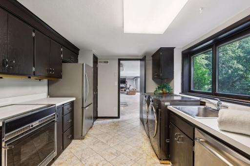 The laundry facilities are conveniently located here as well, and there is a sink and bright windows with pleasant views.