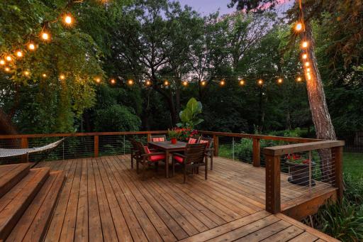 Outdoor entertaining space includes a two-tiered cedar deck with lighting.