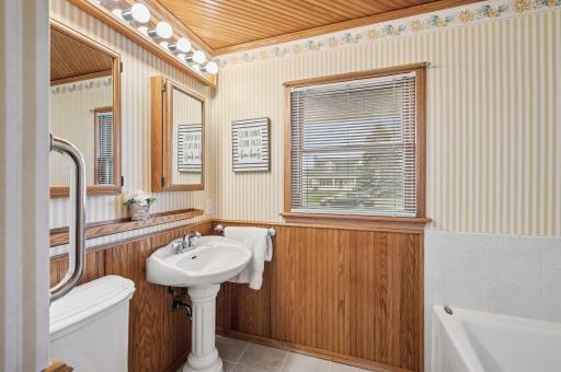 Full bathroom with tub and there is a stand-alone shower in the laundry room.