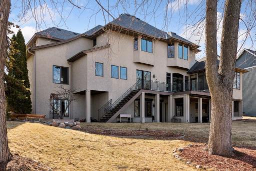 Step outside to stunning lakeside vistas from the back of this home, providing a peaceful retreat and breathtaking scenery just steps away.
