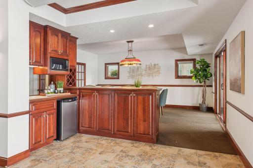 This expertly designed lower-level bar features sleek finishes and ample space, ideal for mixing drinks and entertaining guests in style.