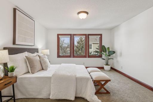 This inviting guest bedroom on the upper level offers comfort and elegance, providing a serene retreat with plenty of space and natural light.