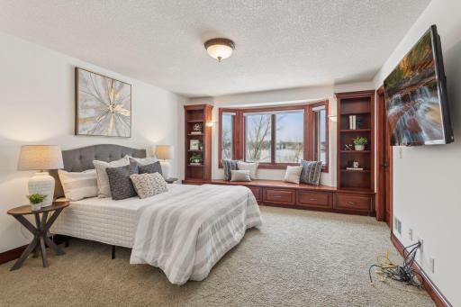 One of two additional bedrooms on the upper level, offering breathtaking lake views and plenty of natural light, perfect for relaxation or creativity.