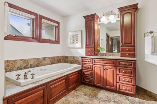 Indulge in total relaxation with this elegant soaking tub, the perfect spot to unwind and melt away the stresses of the day.