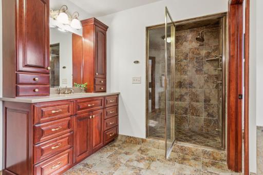 Experience luxury in this expansive walk-in tile shower, featuring sleek glass doors, premium finishes, and a spa-like design.