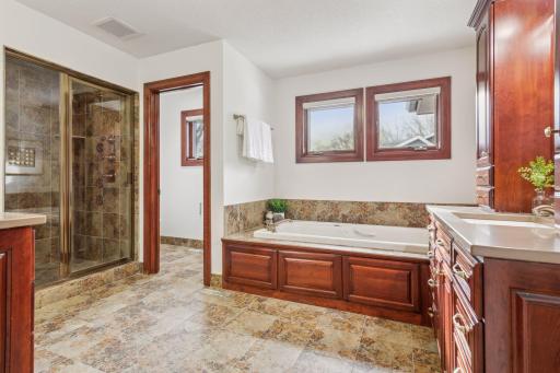 Unwind in luxury with this serene spa-inspired bathroom, featuring a deep soaking tub, elegant finishes, and a calming ambiance.
