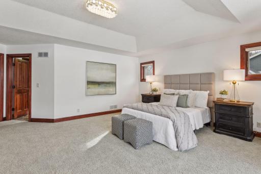 This massive retreat boasts tall ceilings, stunning vista views, a spa-like bath, and spacious custom closets for unparalleled elegance.