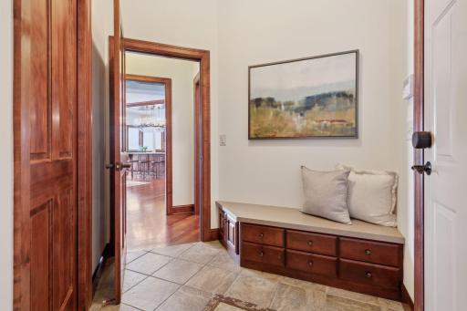 This generously sized mudroom is the perfect drop zone for your busy lifestyle. Located conveniently off the garage, it features ample storage, custom cabinetry, and durable finishes, keeping your home organized.