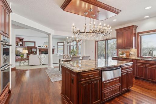 Indulge in this luxurious chef's kitchen, featuring stunning granite countertops, double ovens, and top-of-the-line finishes. All with picturesque lake views to inspire your culinary creations.