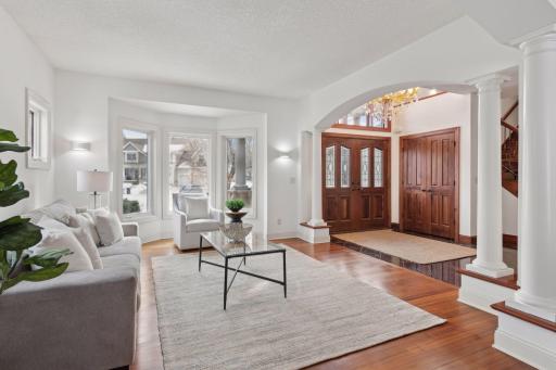 Bright and welcoming, the front living room features charming bay-style windows that fill the space with natural light, creating a cozy yet elegant retreat.