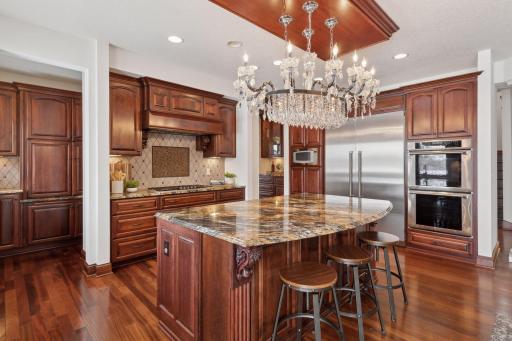 Equipped with high-end appliances and sleek stainless steel double ovens, this kitchen is designed for both style and performance, making it a chef's dream for preparing gourmet meals.