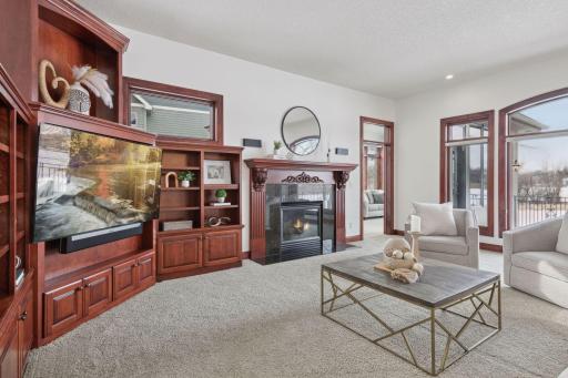 Step into the family room of this exquisite home, where custom storage solutions are seamlessly integrated into the design. Exceptional craftsmanship is evident throughout, blending luxury with practicality for an elevated living experience.