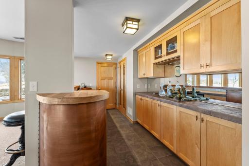 Door behind bar leads to your “4th” smaller garage storage for all your outdoor toys!