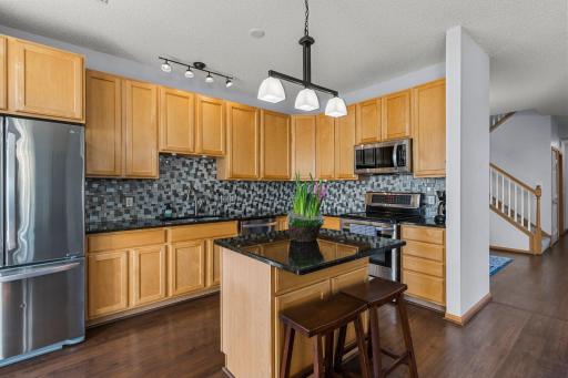 Gorgeous updated kitchen with tile backsplash and granite countertops and stainless steel appliances