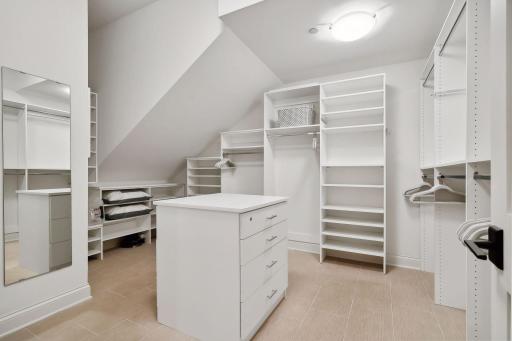 A large walk-in closet is found in the primary suite, along with a secondary smaller walk-in closet (built-in organizational components in all closets)