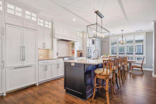 Gourmet kitchen with high-end appliances, beautiful wood floors throughout the condo
