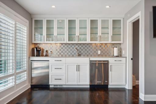 Wet bar with small refrigerator and dishwasher comes in handy when entertaining in this space (powder bath on this level as well)