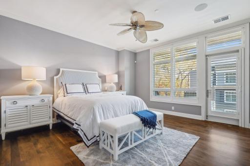 The light-filled primary bedroom has its own private balcony