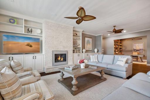 Cozy gas fireplace and custom built-ins anchor one wall of the living room