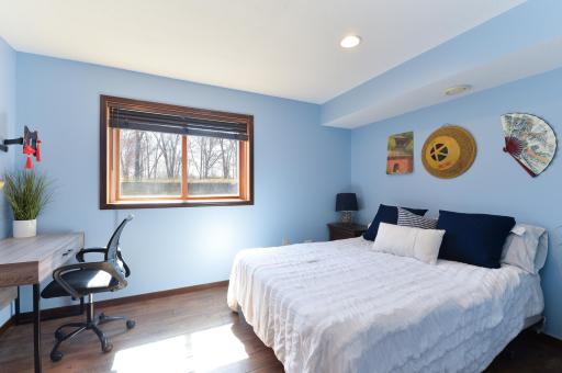 Lower level bedroom offers a secret closet behind the shelves