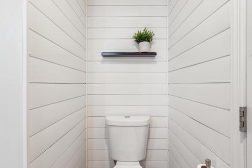 Primary walk-through bathroom features ship lap details