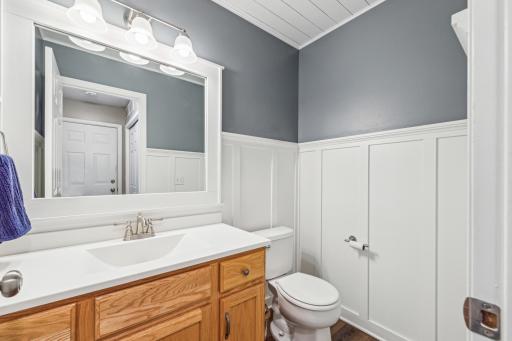 Main floor bathoom w pretty wainscotting details