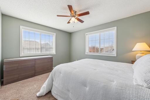 Sunny second bedroom w large windows and generous closet