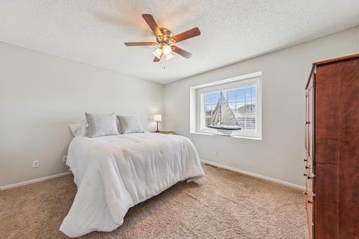 Spacious primary bedroom w large window and walk-in closet and a second closet