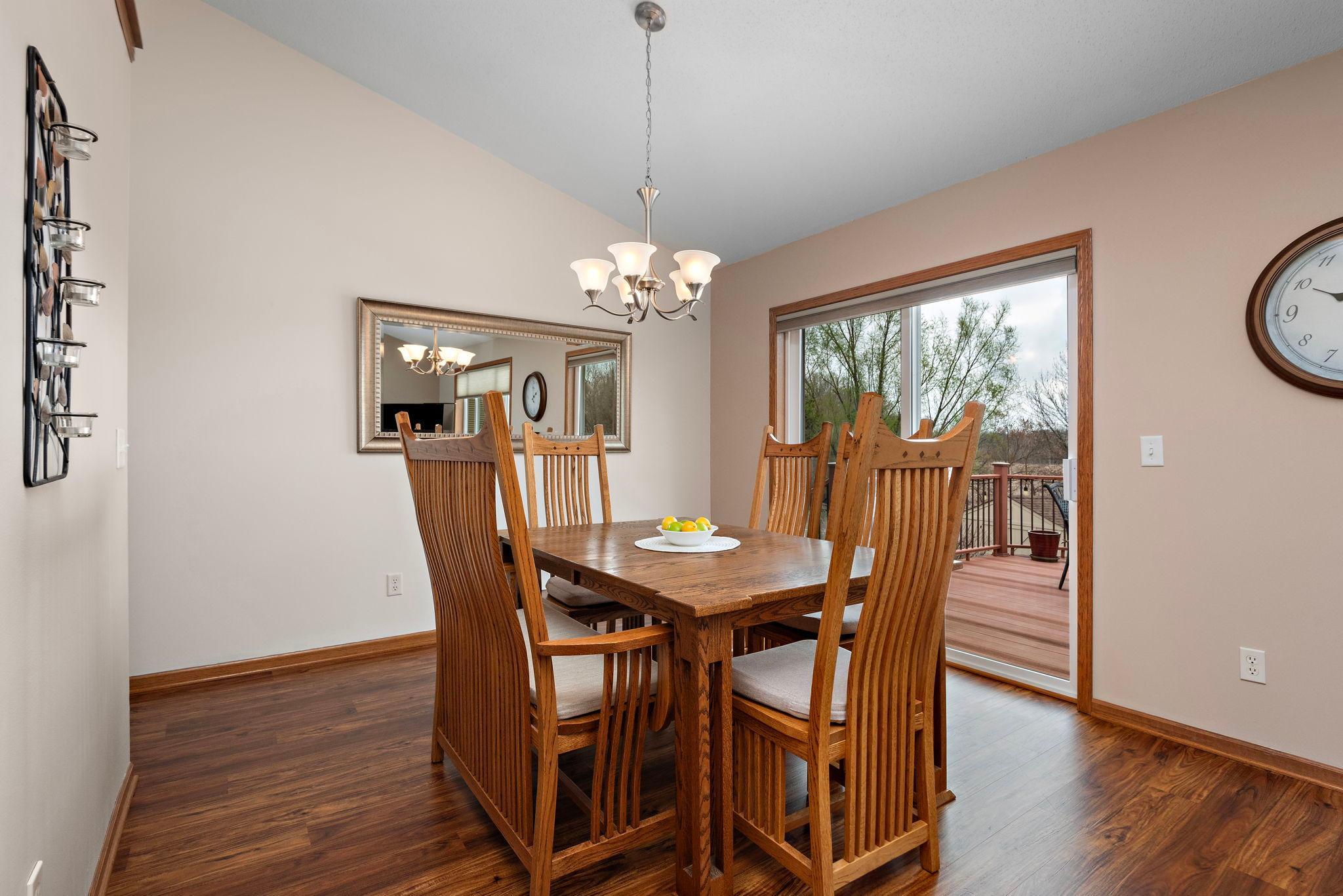 Dining Room has vaulted ceilings, newer flooring, views to back yard and sliding glass door to deck with steps to back private yard!