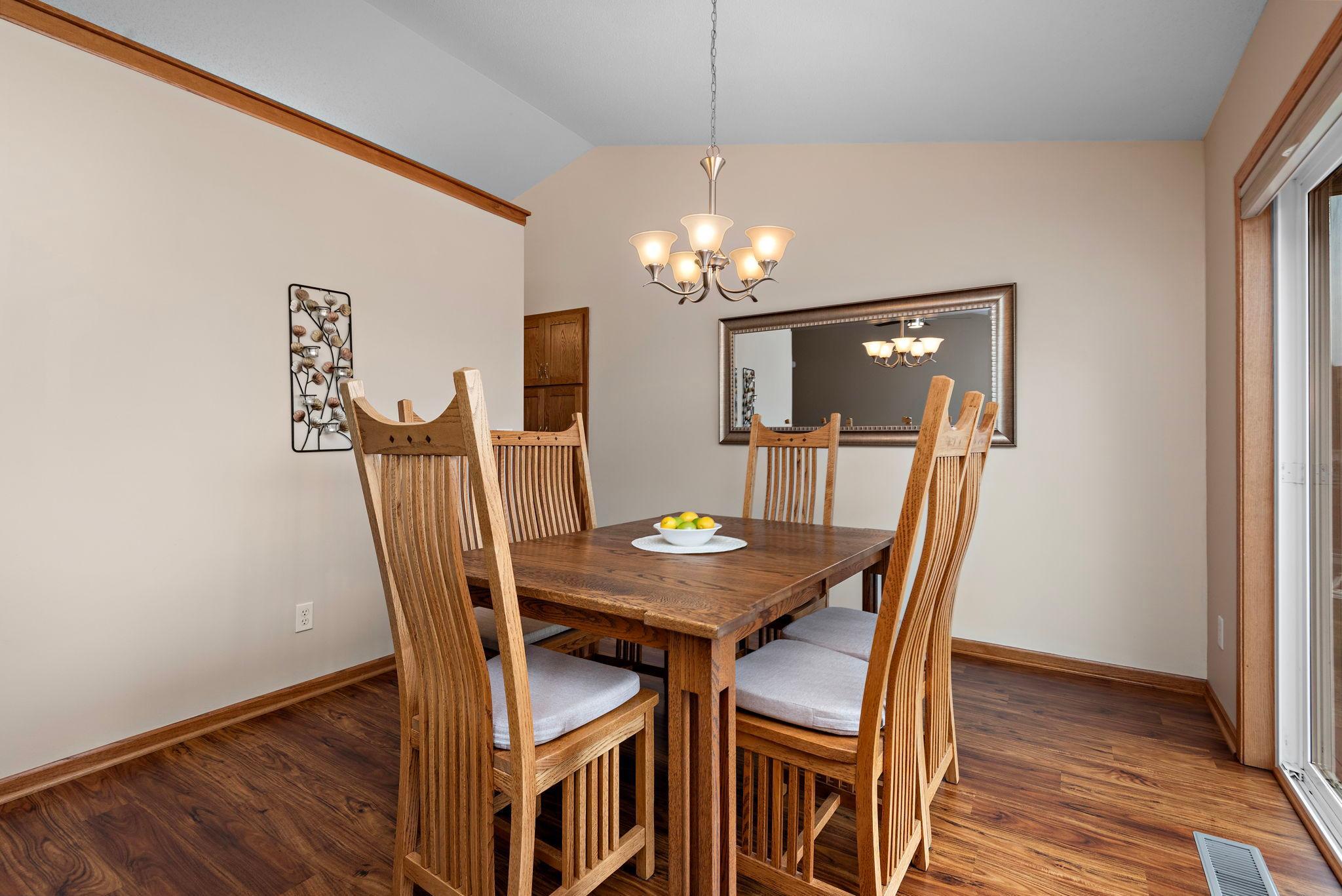 Dining Room has vaulted ceilings, newer flooring, views to back yard and sliding glass door to deck with steps to back private yard!
