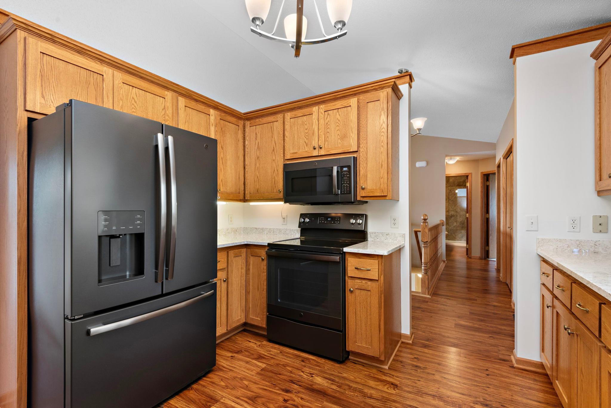 Very nice kitchen with new quartz countertops, all new black stainless steel appliances (2020), new sink, new garbage disposal, built-in pantry cabinet and vinyl plank flooring!