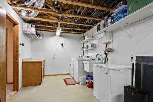 Lower Level laundry and utility room has utility sink with lots of storage space!