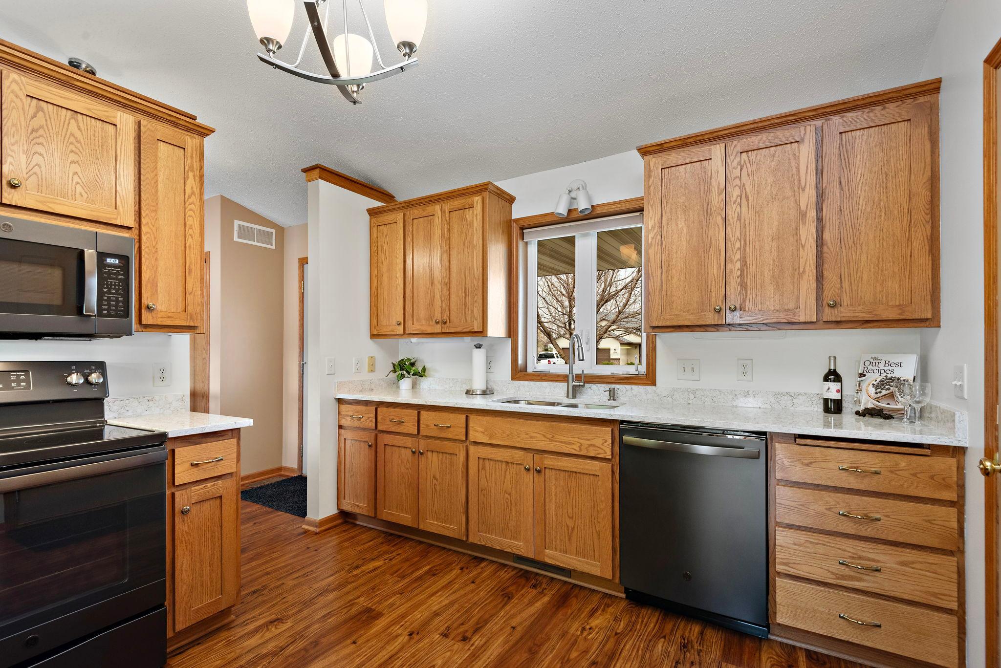 Very nice kitchen with new quartz countertops, all new black stainless steel appliances (2020), new sink, new garbage disposal, built-in pantry cabinet and vinyl plank flooring!